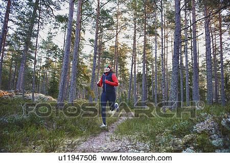 Woman running in forest View Large Photo Image Stock Photograph - Woman running in forest. Fotosearch