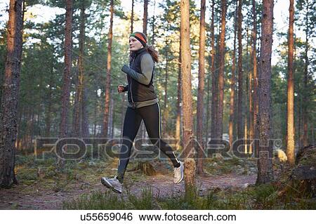 Stock Photograph - Woman running in forest. Fotosearch