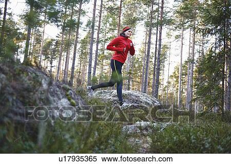 Stock Photography - Woman running in forest. Fotosearch