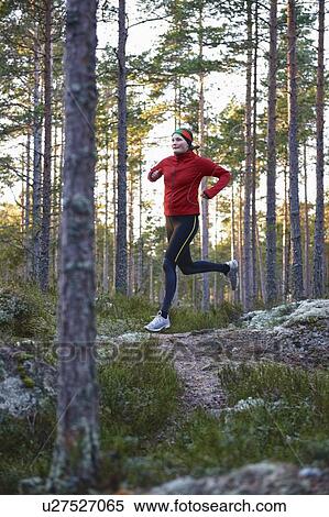 Stock Photography - Woman running in forest. Fotosearch