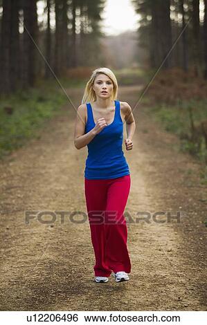 Woman running in woods View Large Photo Image Stock Photograph - Woman running in woods. Fotosearch