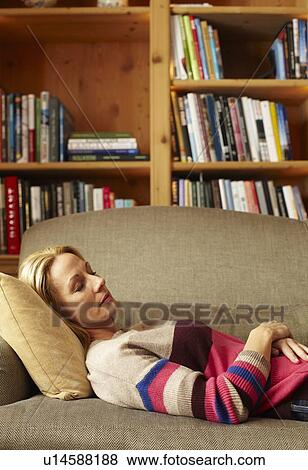 Stock Photo - Woman sleeping on sofa. Fotosearch