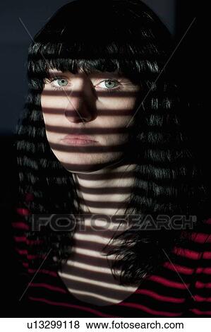 Woman standing in blinds shadow View Large Photo Image Stock Photo - Woman standing in blinds shadow. Fotosearch
