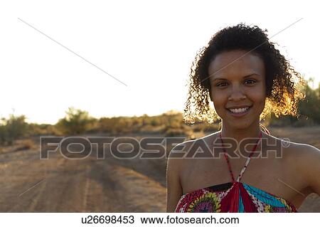 Woman standing in desert landscape View Large Photo Image Stock Image - Woman standing in desert landscape. Fotosearch