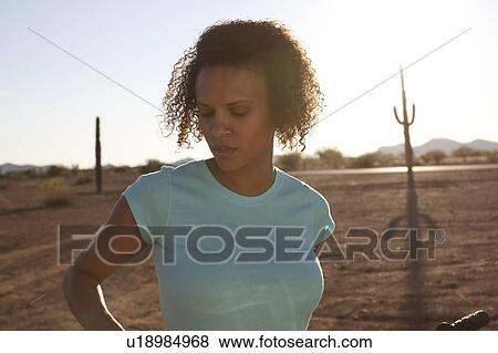 Woman standing in desert landscape View Large Photo Image Stock Photo - Woman standing in desert landscape. Fotosearch