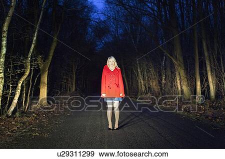 Woman standing on road in woods View Large Photo Image Stock Photo - Woman standing on road in woods. Fotosearch