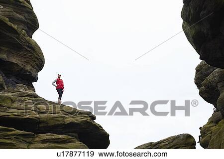 Woman standing on rock formations View Large Photo Image Stock Photo - Woman standing on rock formations. Fotosearch