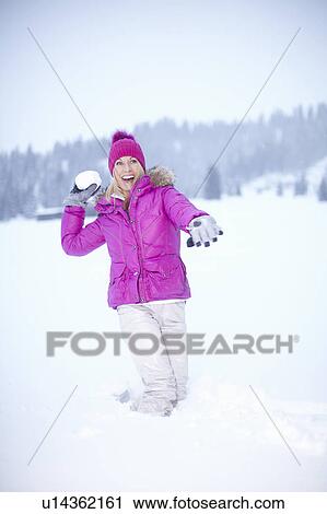 Woman throwing snowball outdoors View Large Photo Image Stock Image - Woman throwing snowball outdoors. Fotosearch