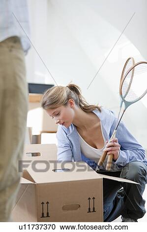 Woman unpacking cardboard box View Large Photo Image Stock Image - Woman unpacking cardboard box. Fotosearch