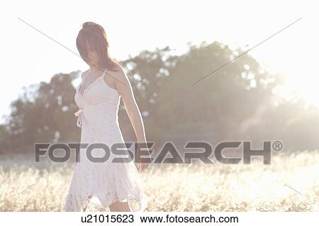 Woman walking in wheatfield View Large Photo Image Stock Image - Woman walking in wheatfield. Fotosearch