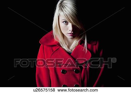 Stock Photo - Woman wearing red coat outdoors. Fotosearch