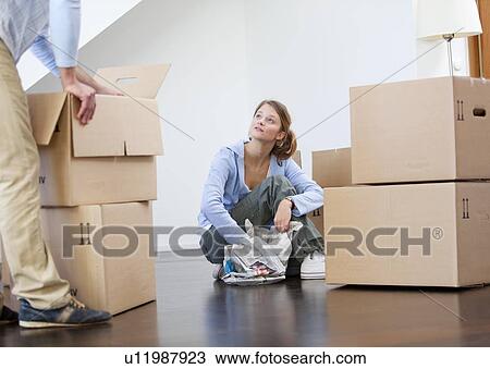 Woman wrapping dishes to pack View Large Photo Image Stock Image - Woman wrapping dishes to pack. Fotosearch