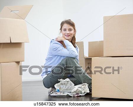Woman wrapping dishes to pack View Large Photo Image Stock Photography - Woman wrapping dishes to pack. Fotosearch