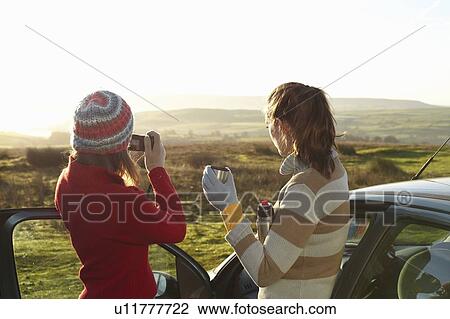 Stock Image - Women admiring landscape from car. Fotosearch