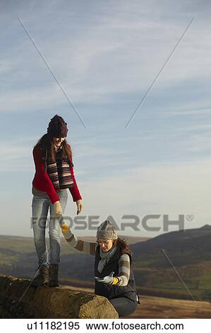 Women climbing rock wall together View Large Photo Image Stock Photography - Women climbing rock wall together. Fotosearch