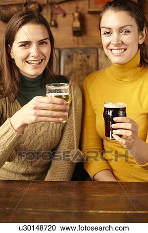 Women drinking beer in pub View Large Photo Image Stock Image - Women drinking beer in pub. Fotosearch