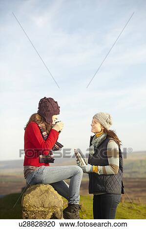 Women drinking coffee from thermos View Large Photo Image Stock Image - Women drinking coffee from thermos. Fotosearch