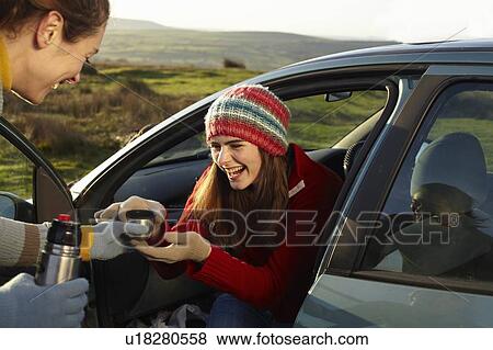 Women drinking coffee from thermos View Large Photo Image Stock Photo - Women drinking coffee from thermos. Fotosearch
