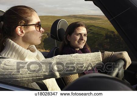 Stock Photo - Women driving in rural landscape. Fotosearch
