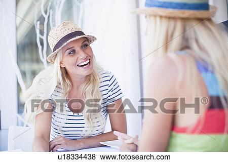 Women in sunhats talking in cafe View Large Photo Image Stock Photo - Women in sunhats talking in cafe. Fotosearch