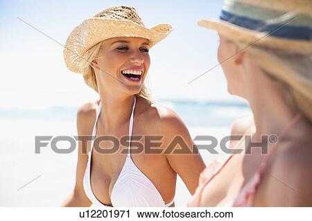 Women laughing together on beach View Large Photo Image Stock Image - Women laughing together on beach. Fotosearch