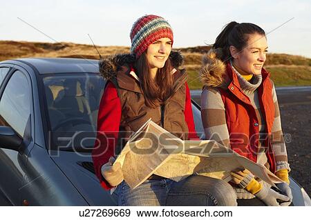 Stock Photo - Women reading map by car. Fotosearch