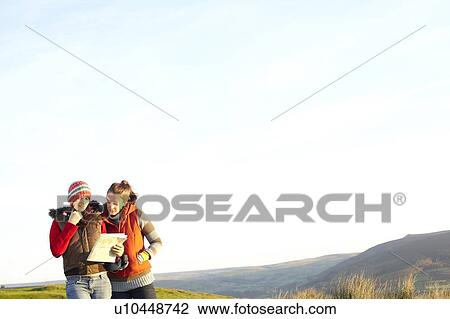 Women reading map outdoors View Large Photo Image Stock Image - Women reading map outdoors. Fotosearch