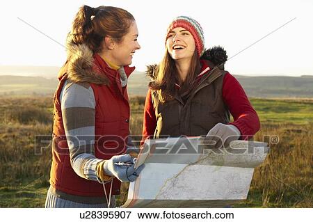 Stock Photo - Women reading map outdoors. Fotosearch