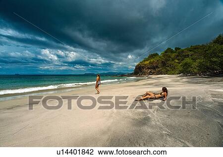 Women relaxing on tropical beach View Large Photo Image Stock Image - Women relaxing on tropical beach. Fotosearch