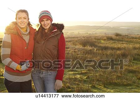 Stock Photo - Women smiling together outdoors. Fotosearch