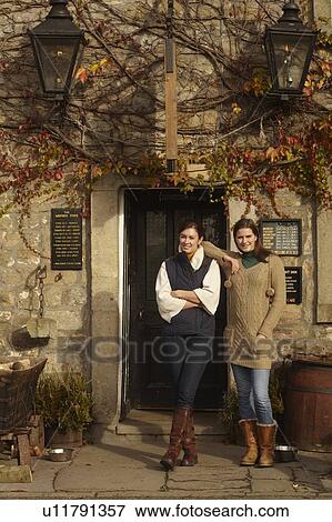 Women standing at historic building View Large Photo Image Stock Photo - Women standing at historic building. Fotosearch