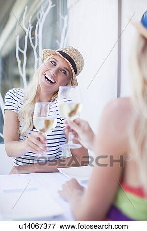 Women toasting each other with wine View Large Photo Image Stock Photo - Women toasting each other with wine. Fotosearch