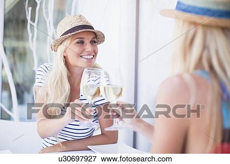 Women toasting each other with wine View Large Photo Image Stock Photo - Women toasting each other with wine. Fotosearch