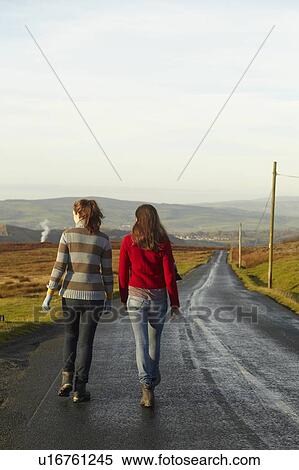 Women walking on rural road View Large Photo Image Stock Photography - Women walking on rural road. Fotosearch
