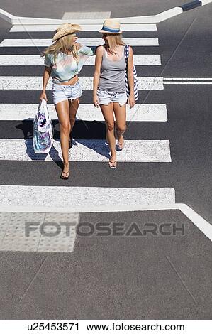 Women walking together on city street View Large Photo Image Stock Image - Women walking together on city street. Fotosearch