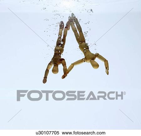 Wooden figurines splashing in water View Large Photo Image Stock Photography - Wooden figurines splashing in water. Fotosearch