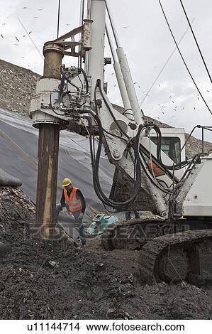 Picture - Worker at garbage collection center. Fotosearch