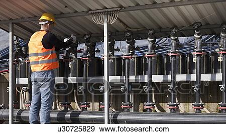 Stock Photo - Worker at garbage collection center. Fotosearch
