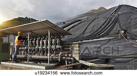 Stock Photograph - Worker at garbage collection center. Fotosearch