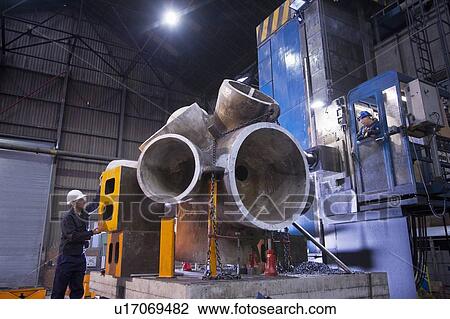 Worker using machinery in steel forge View Large Photo Image Stock Image - Worker using machinery in steel forge. Fotosearch