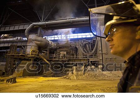 Worker walking in steel forge View Large Photo Image Stock Image - Worker walking in steel forge. Fotosearch