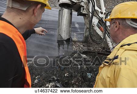 Stock Image - Workers at garbage collection center. Fotosearch