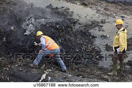 Stock Photo - Workers at garbage collection center. Fotosearch