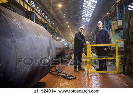 Workers talking in steel forge View Large Photo Image Picture - Workers talking in steel forge. Fotosearch
