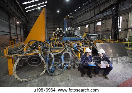 Workers talking in steel forge View Large Photo Image Picture - Workers talking in steel forge. Fotosearch