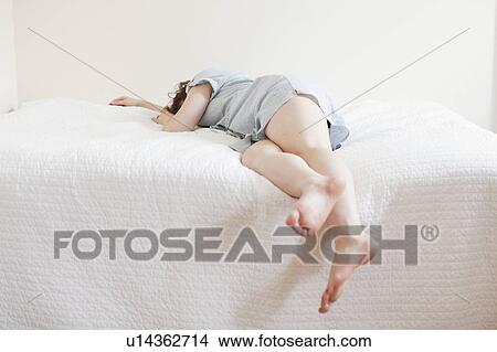 Attractive young woman sleeping in bed View Large Photo Image Picture - Attractive young woman sleeping in bed. Fotosearch