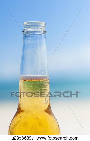 Beer bottle on beach View Large Photo Image Stock Photo - Beer bottle on beach. Fotosearch