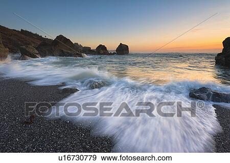 Blurred surf wave washing ashore View Large Photo Image Stock Photo - Blurred surf wave washing ashore. Fotosearch