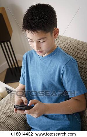 Boy (10-11) using mobile phone View Large Photo Image Stock Image - Boy (10-11) using mobile phone. Fotosearch