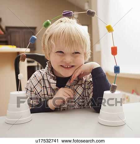 Boy (4-5) with his craft work View Large Photo Image Stock Image - Boy (4-5) with his craft work. Fotosearch